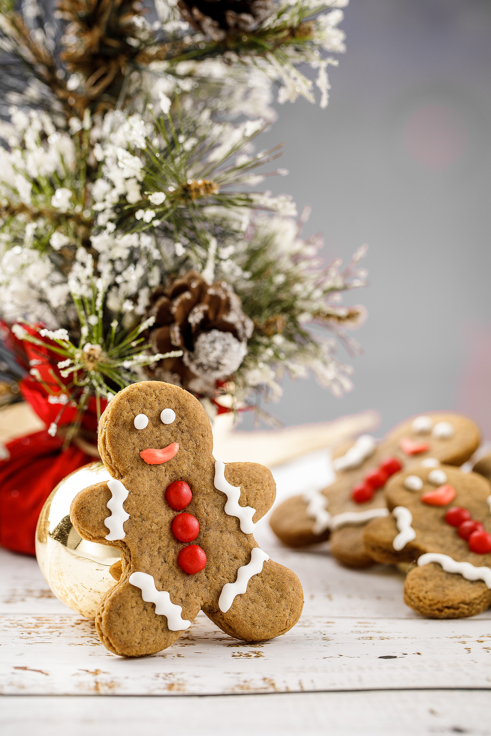 Vegan gingerbread man cookies displayed in a snowy holiday setting, created for a festive Christmas cookie cookbook.