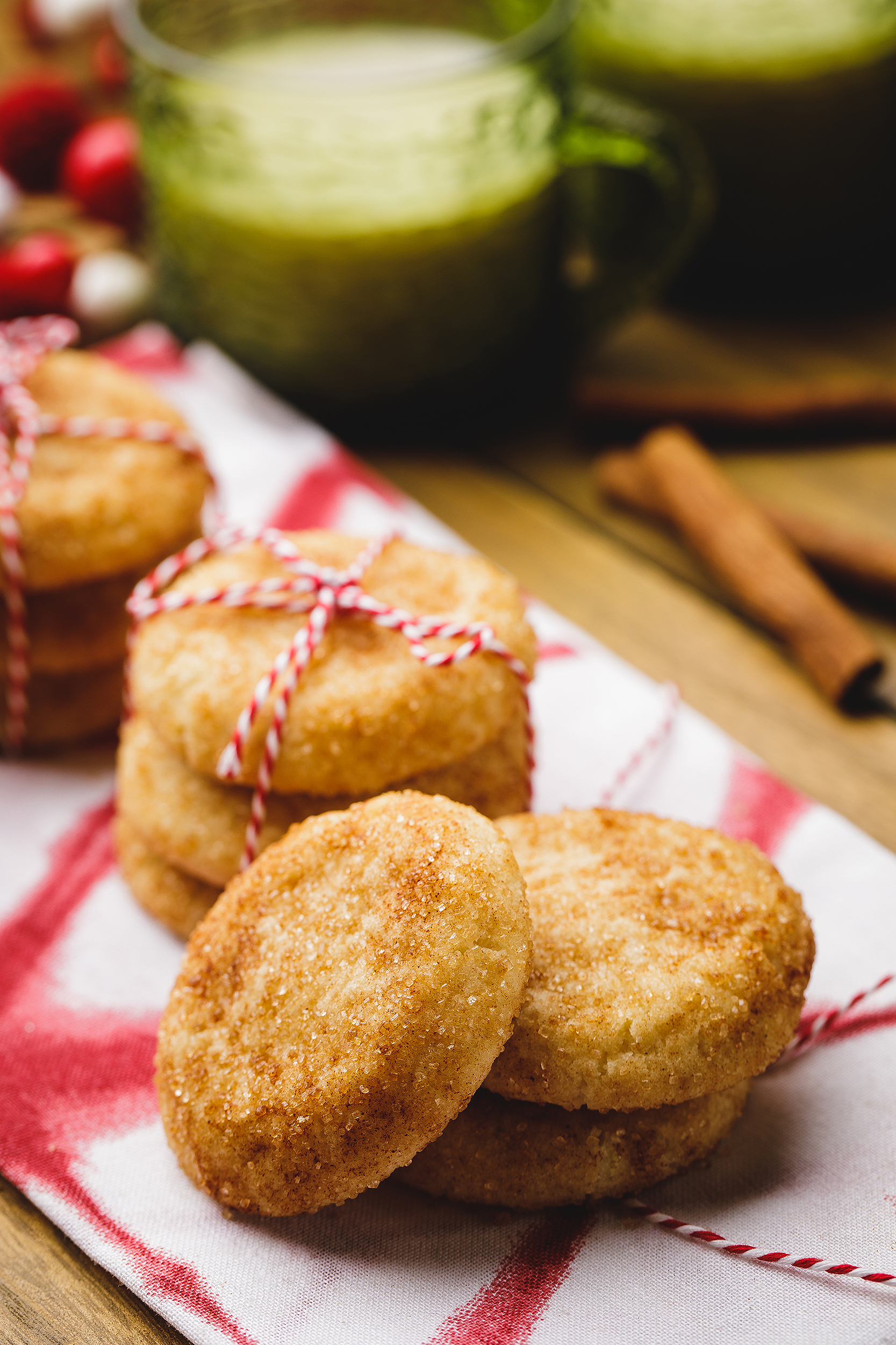Vegan snickerdoodle cookies tied with festive twine, styled for a holiday baking cookbook photoshoot.