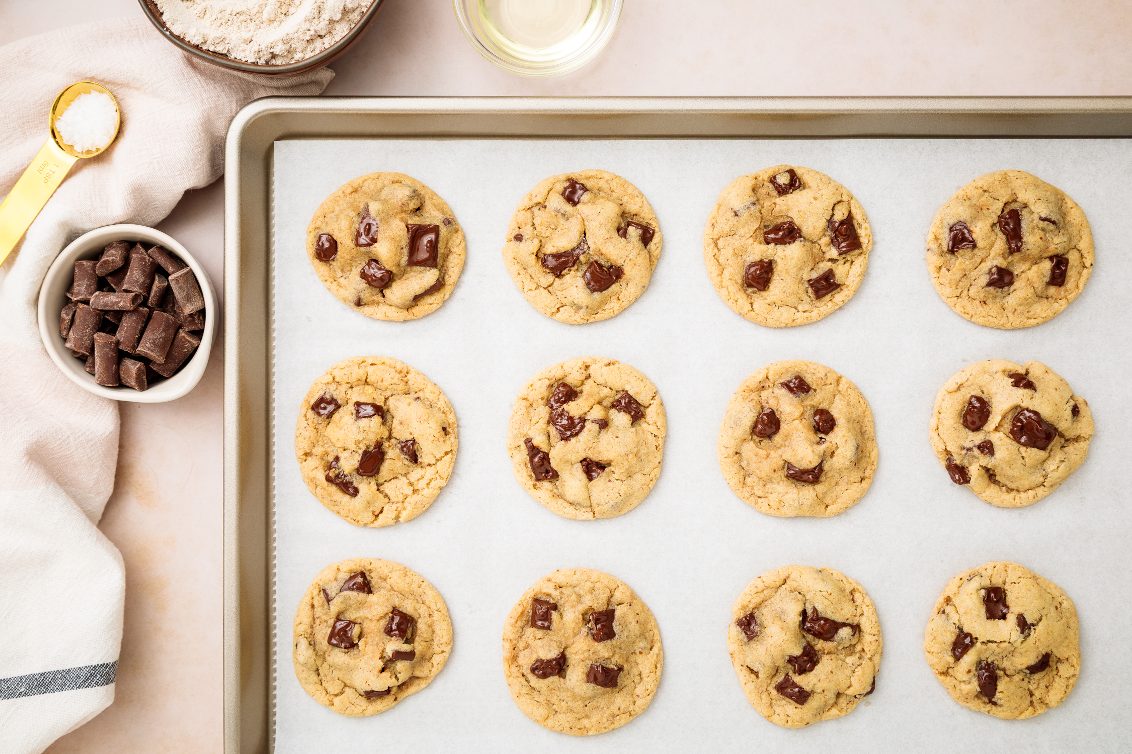 Overhead food photograph of chocolate chip cookies on a baking sheet, styled for bakery and dessert food photography.