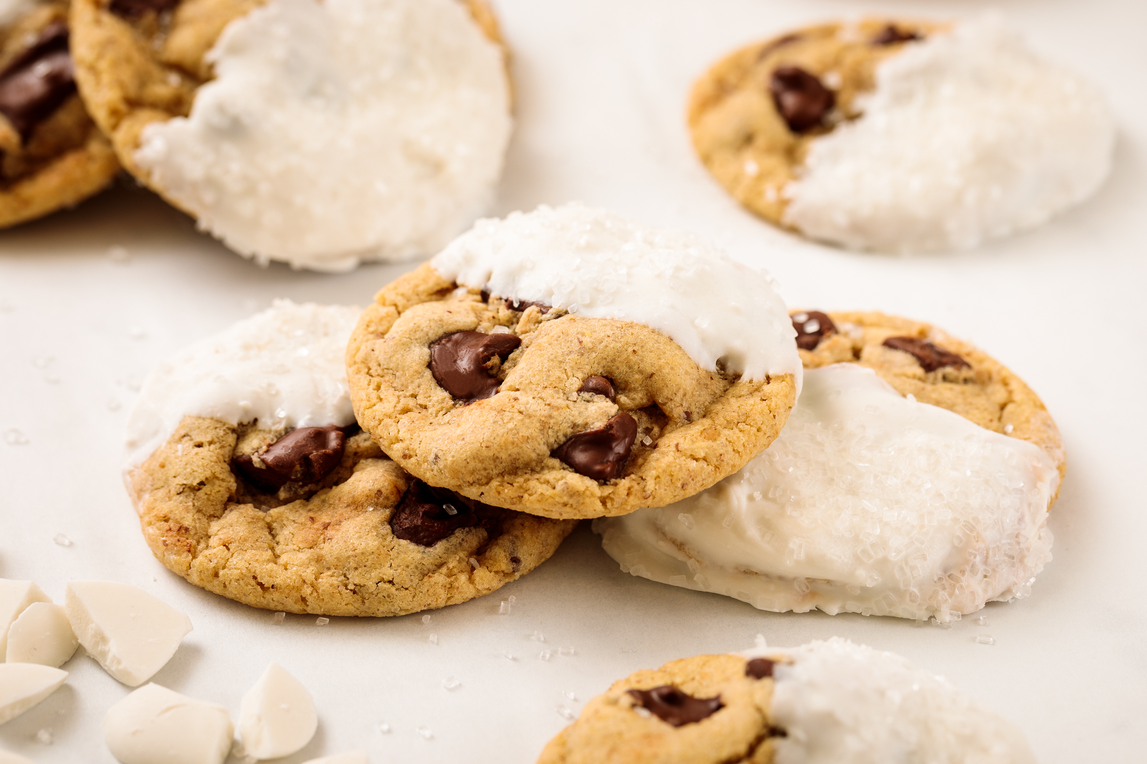 Chocolate chip cookies partially dipped in white chocolate, photographed for dessert branding and product photography.