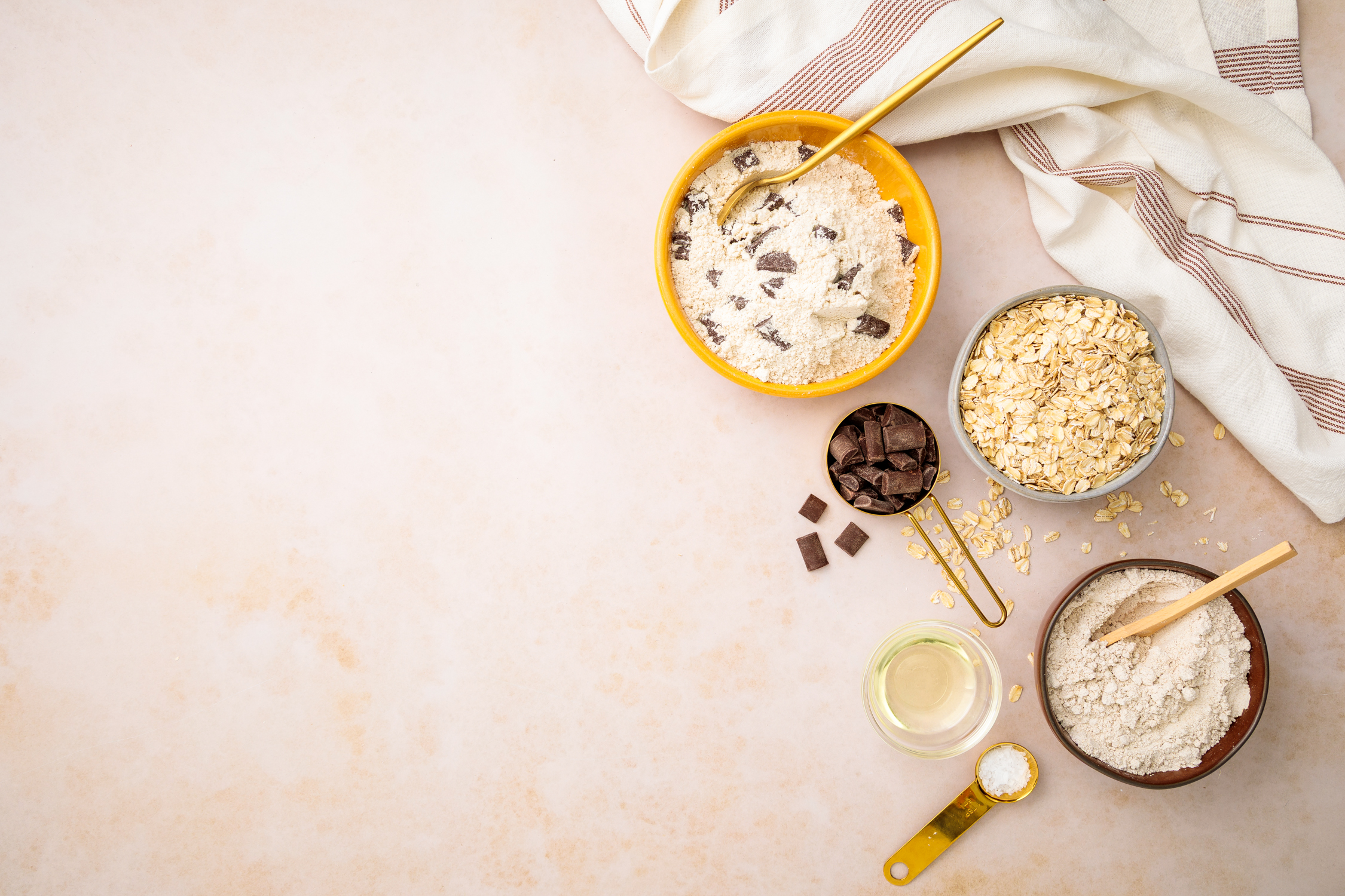 Flat lay food photography of cookie ingredients and dough styled for recipe development and dessert brand marketing.