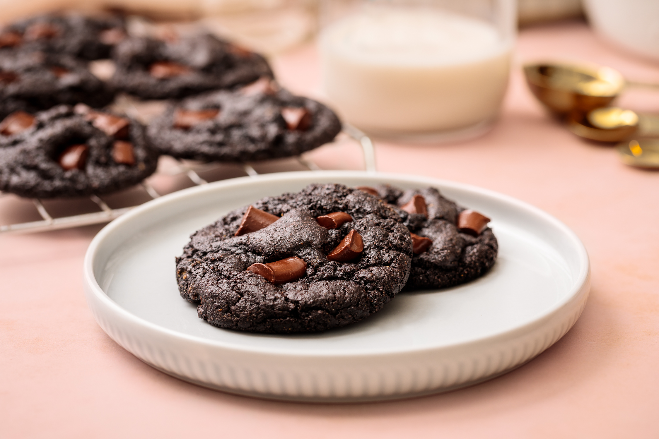 Plated chocolate cookies photographed in soft studio light for bakery marketing and dessert food photography.