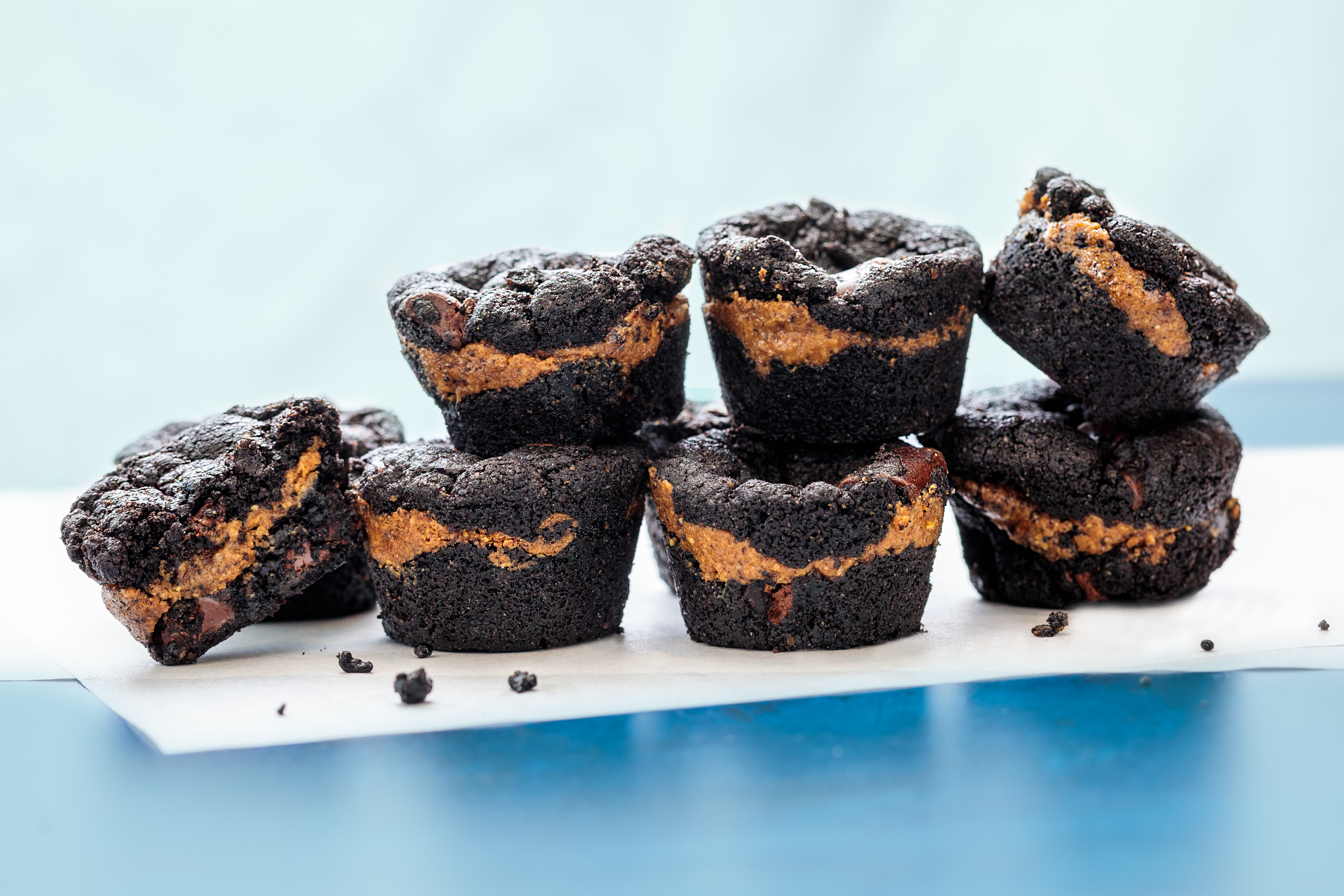 Stacked chocolate brownies with layered filling photographed for bakery, dessert, and food brand marketing.