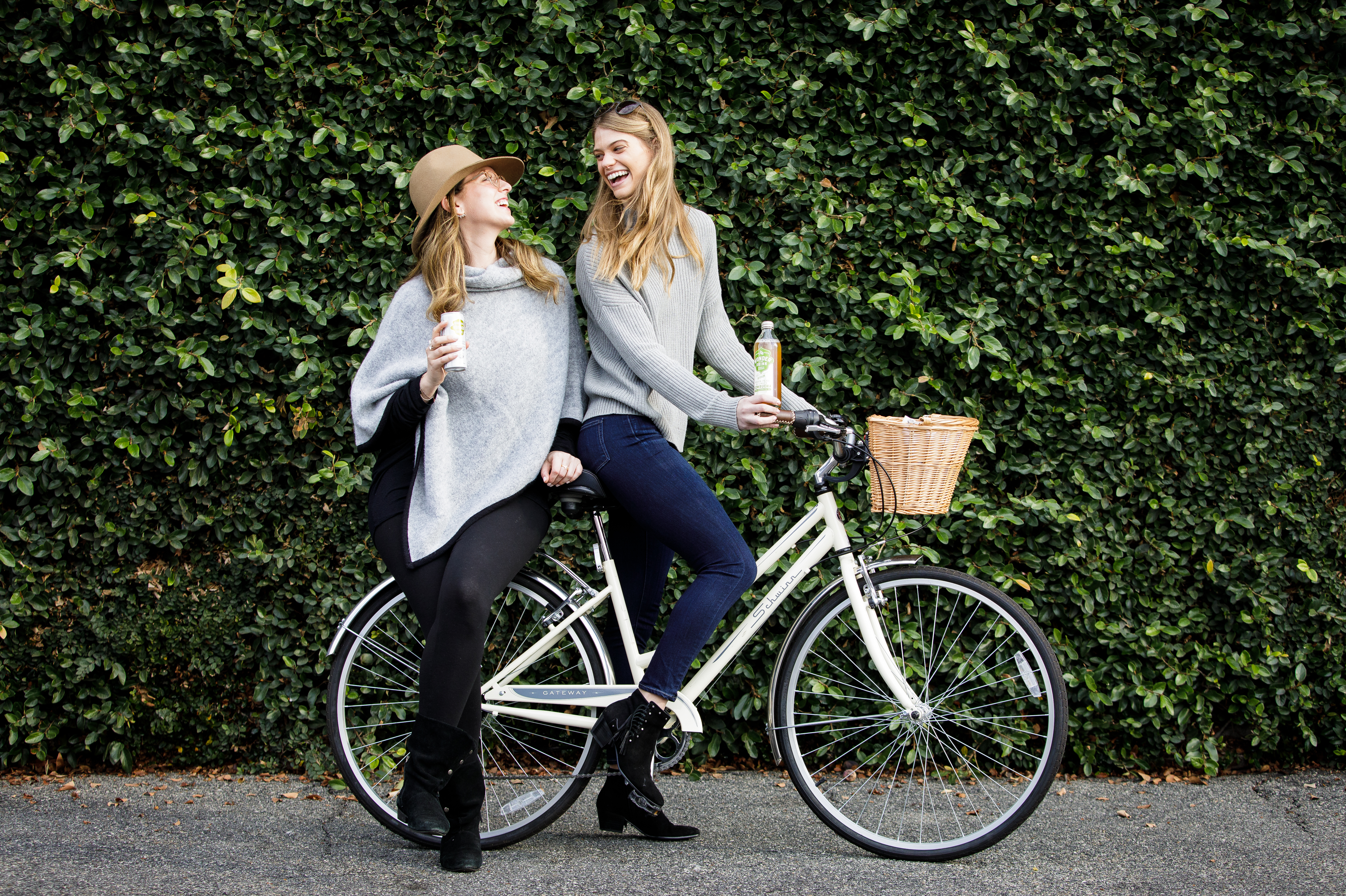 Lifestyle beverage photography of women riding a bicycle with bottled drinks, photographed in Los Angeles for food and beverage brand storytelling.