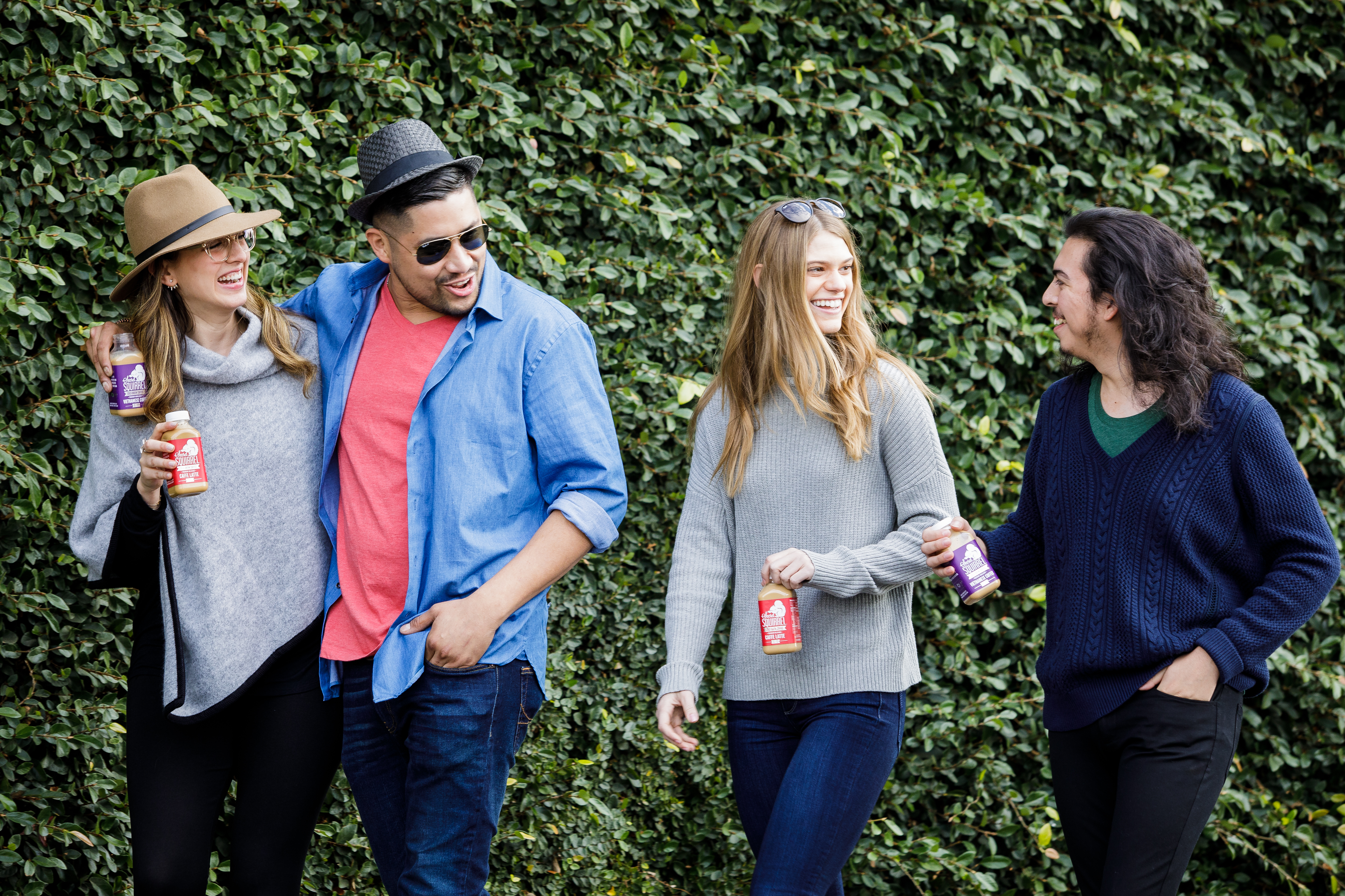 Lifestyle beverage photography of friends walking outdoors with bottled drinks, photographed in Los Angeles for food, beverage, and brand marketing campaigns.