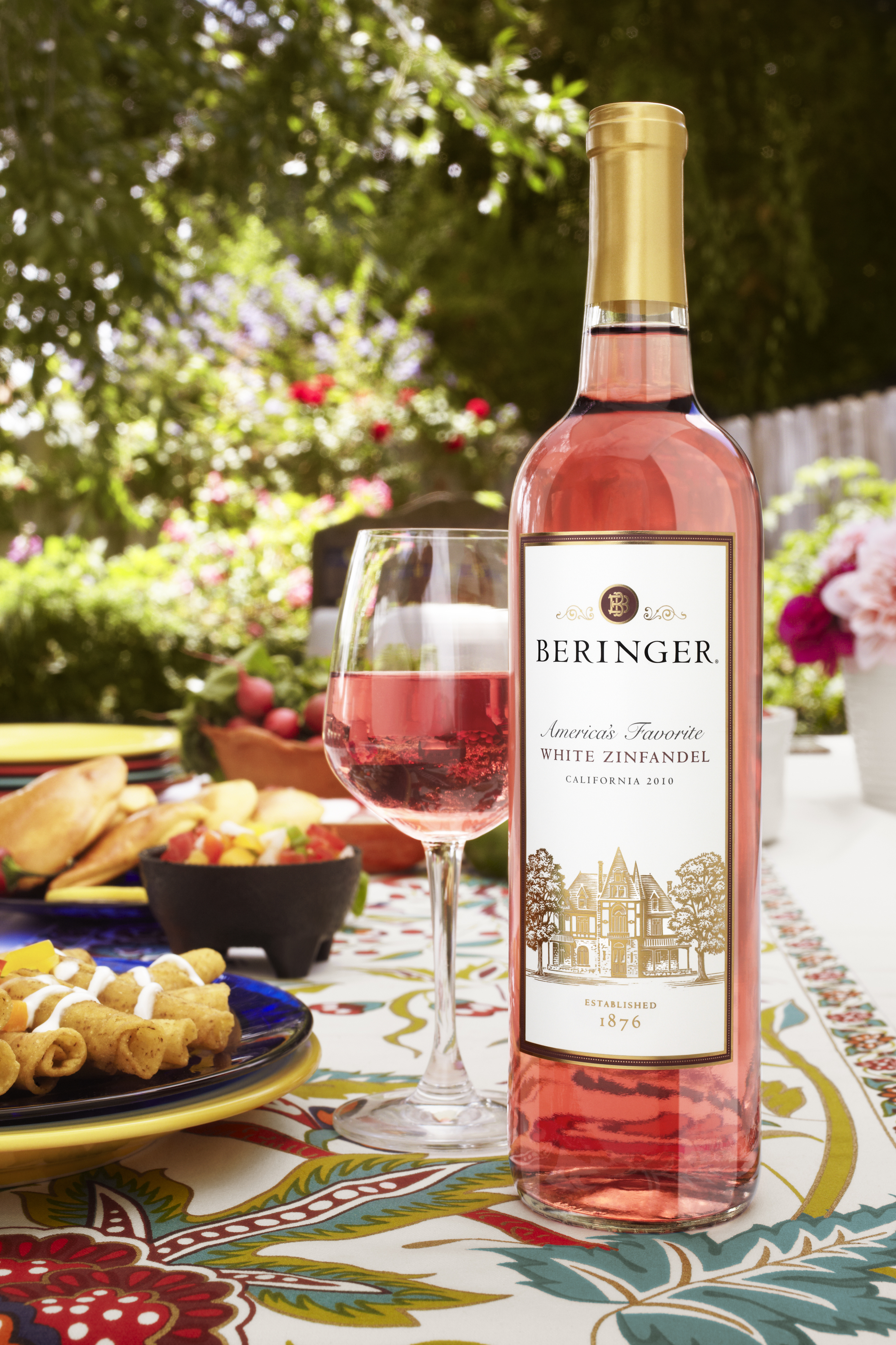 Commercial wine photography of a rosé wine bottle and glass styled on an outdoor table, photographed in Los Angeles for food, beverage, and wine brand marketing.