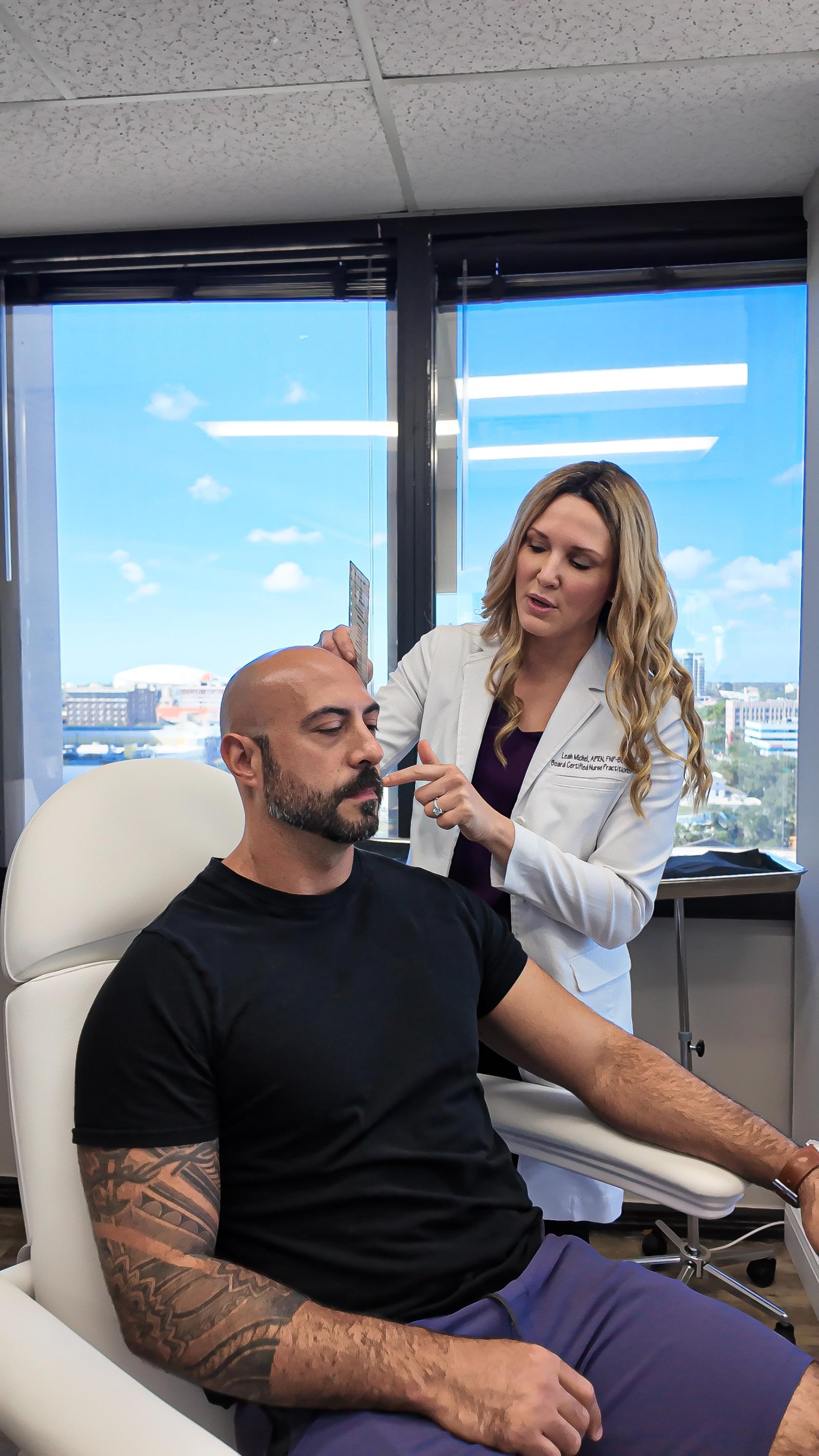 Dermatology provider performing a full body skin exam on a patient in St. Petersburg, Florida Dermatology provider performing a full body skin exam on a patient in St. Petersburg, Florida