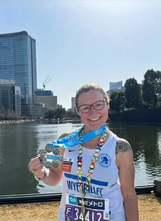Ann Pritchard holding her World Marathon Majors medals in Tokyo