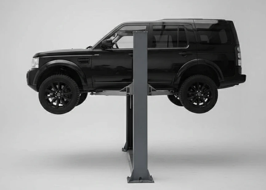 A black car facing left on a 2 post ramp