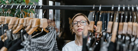 A woman browsing a rail in a shop