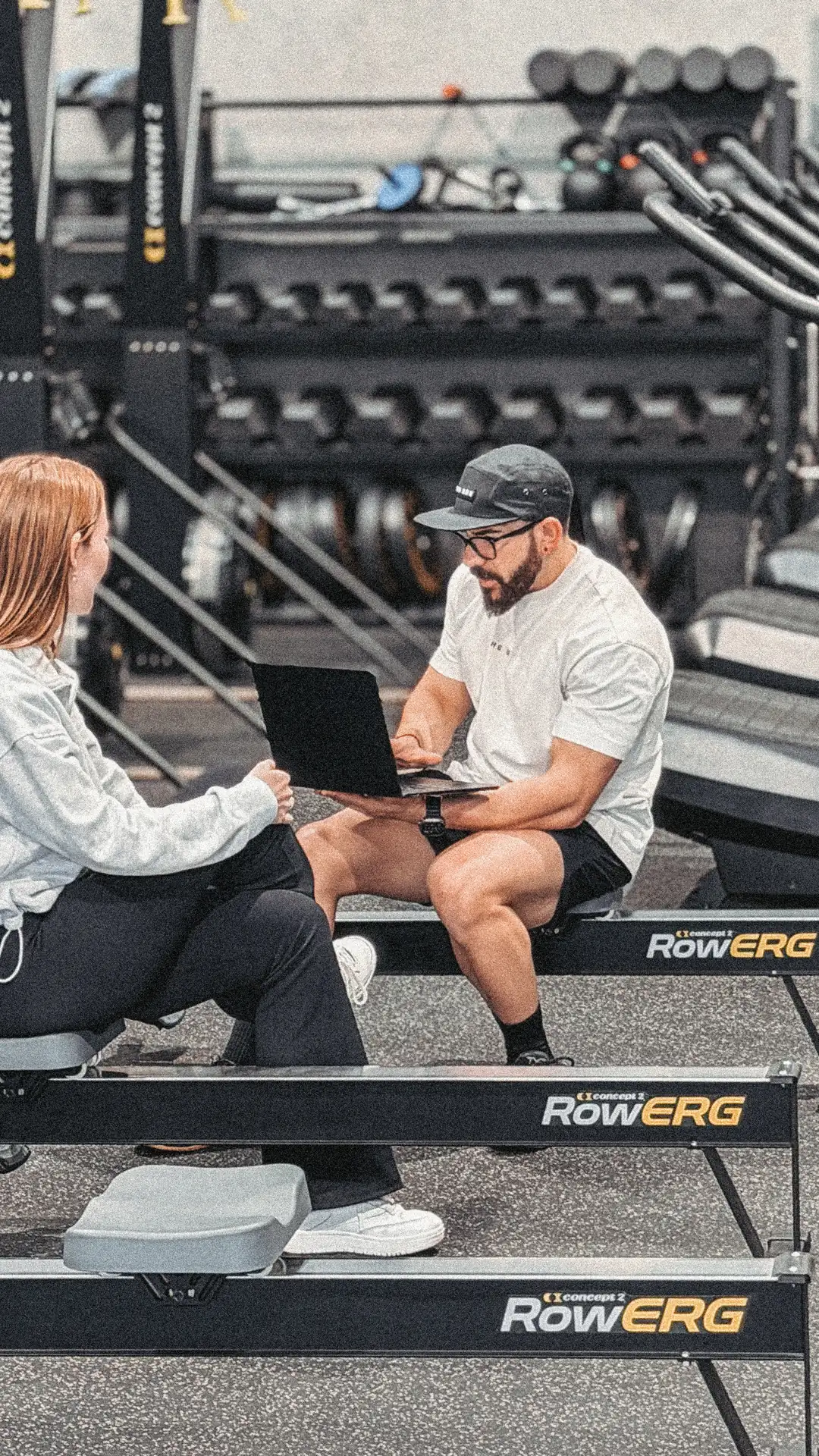 Coach at The Box going through a member's body composition results on a laptop