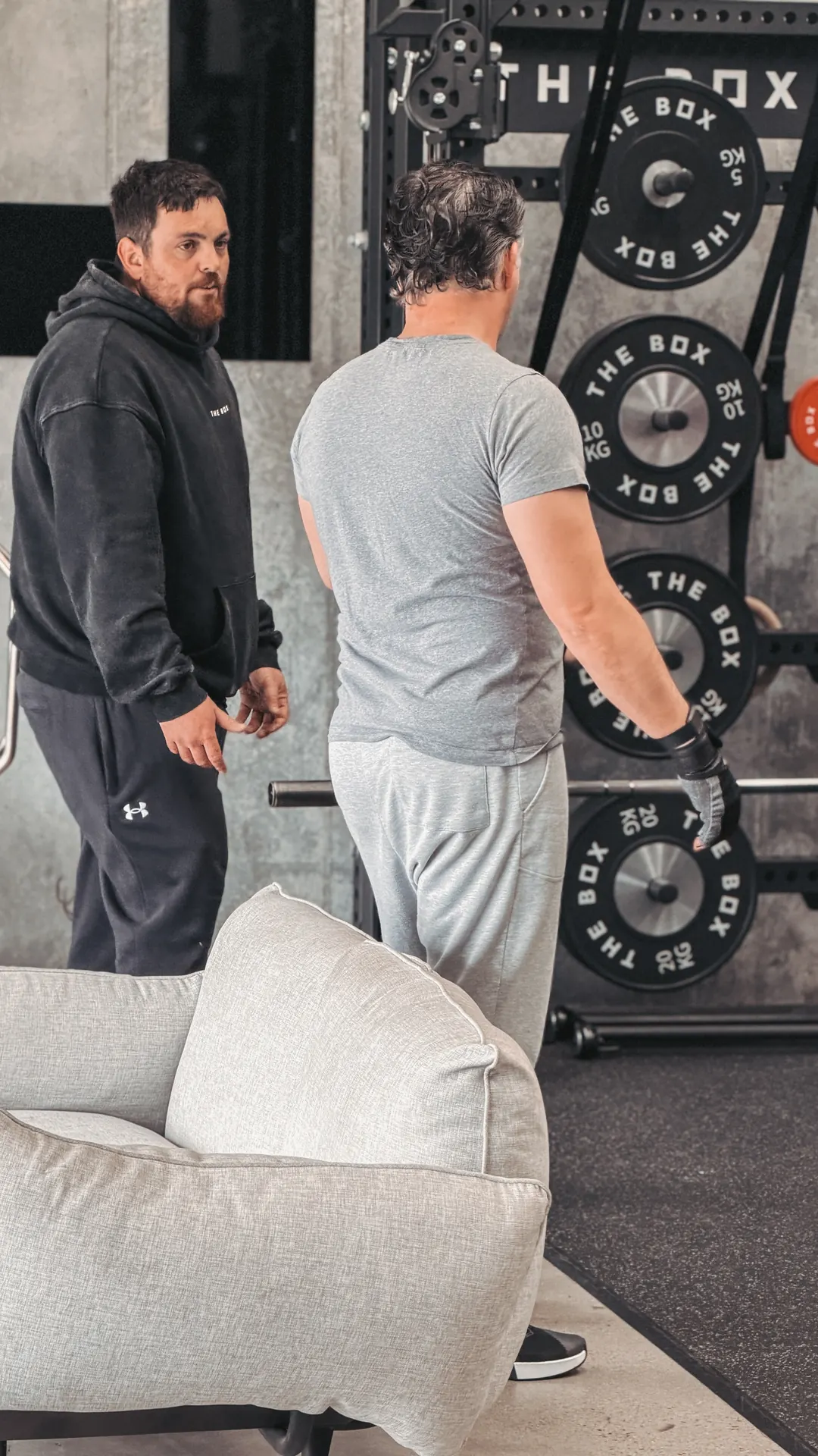 Coach and member chatting by the rack