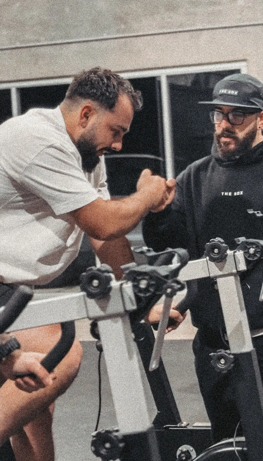 Coach fist-bumping a member on the bike
