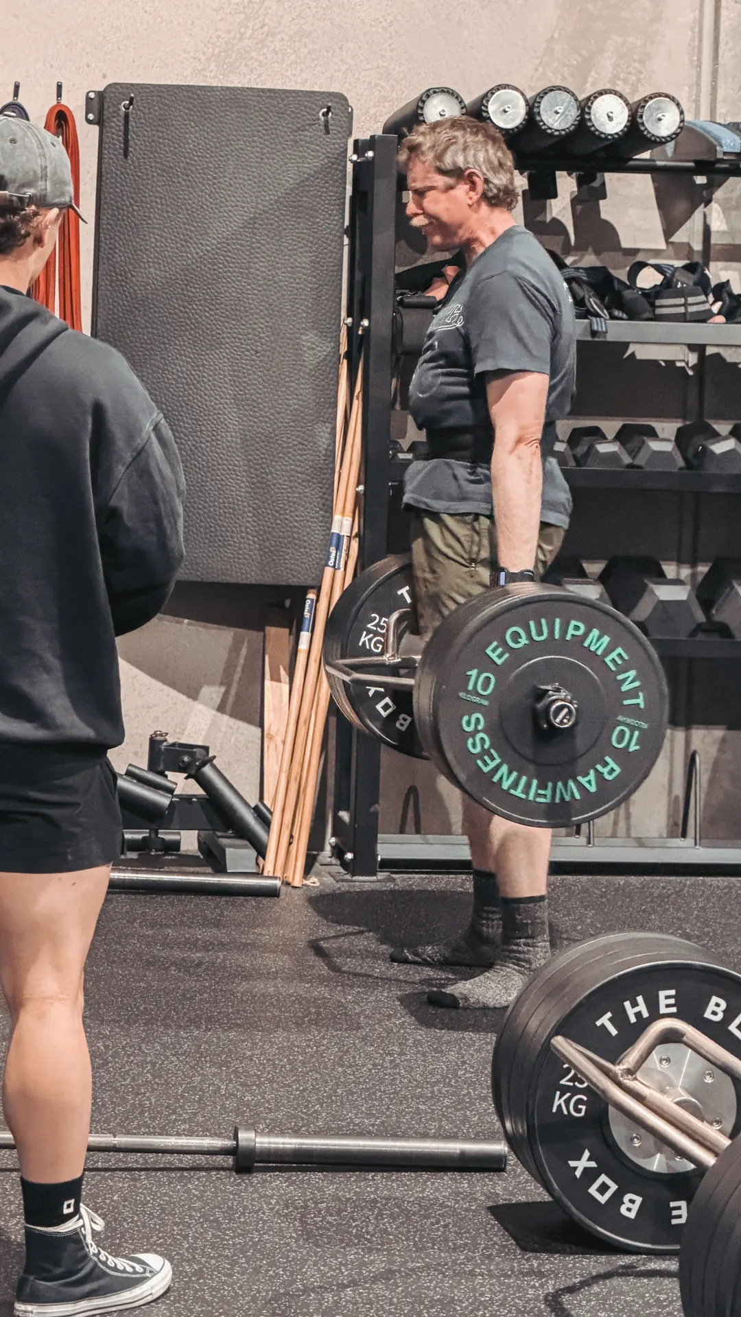 Member of The Box deadlifting with a coach nearby. All ages and levels train here