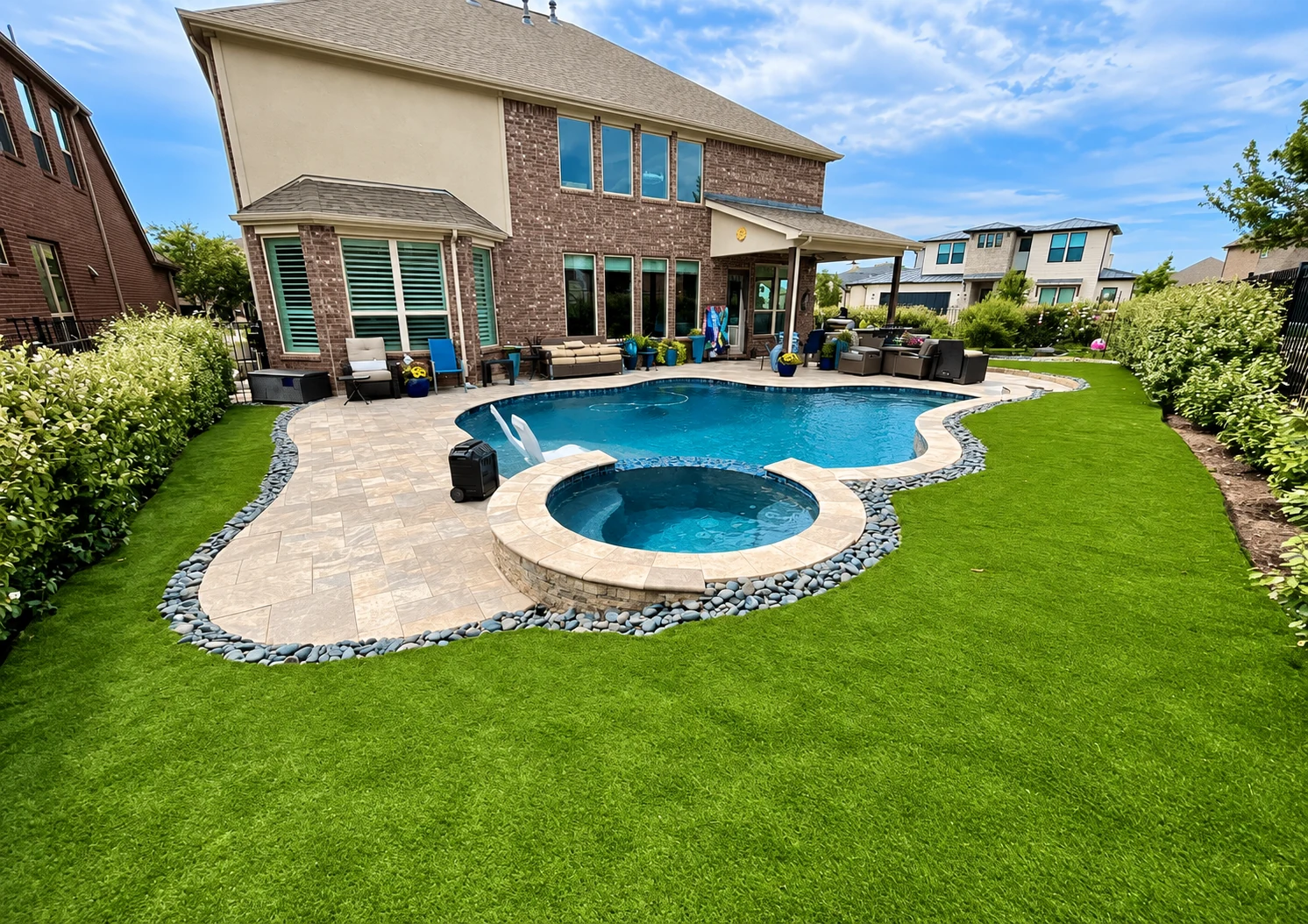 Decorative Brazos rock bed with clean borders and low-maintenance planting for a durable, finished look.