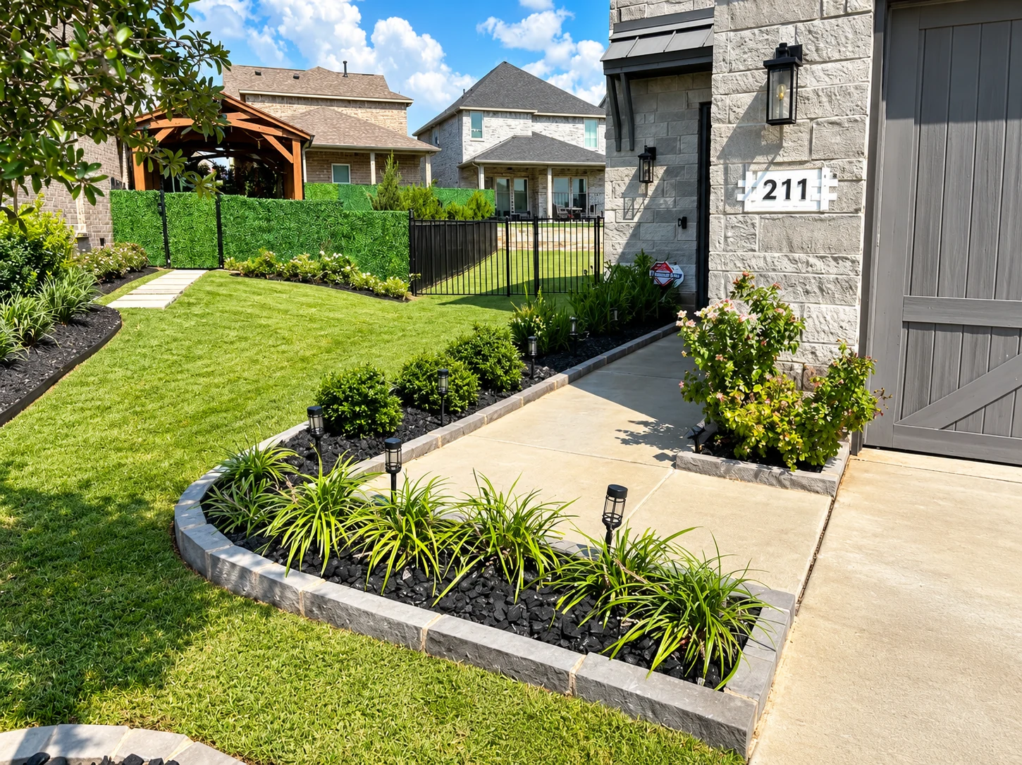 Uniform line of evergreen privacy shrubs planted along the perimeter fence for natural screening.