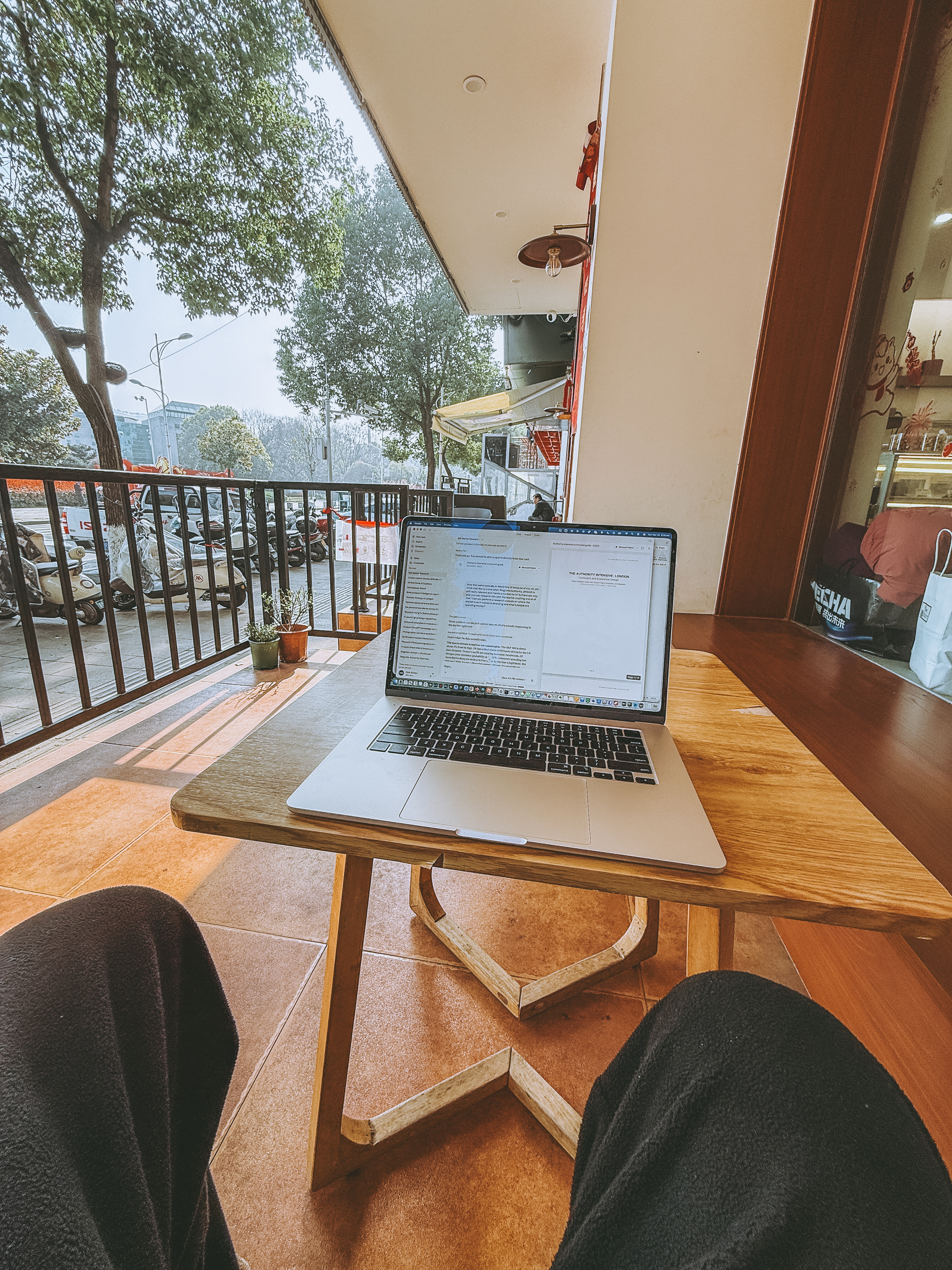 Laptop open at a Wudang cafe, building the Brand Intelligence Engine