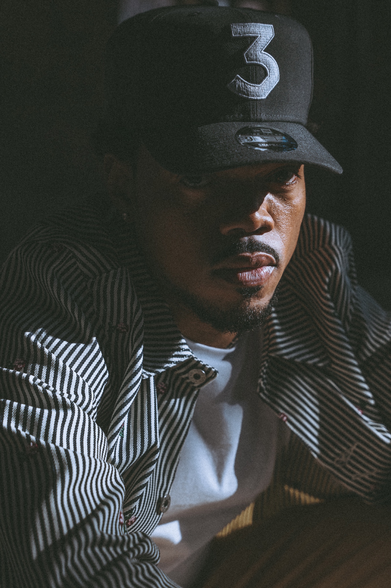 Chance the Rapper in a dark close-up portrait, photographed by Nick Onken