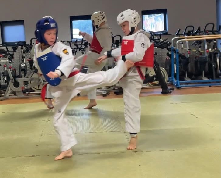 Young Warrior Taekwondo students sparring in class Young Warrior Taekwondo students sparring in class