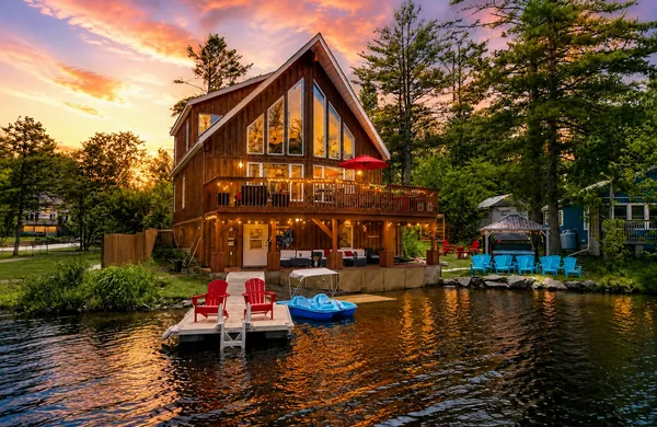 Good Times, an A-frame cottage on Morrison Lake near Gravenhurst, at sunset with its dock and paddle boat