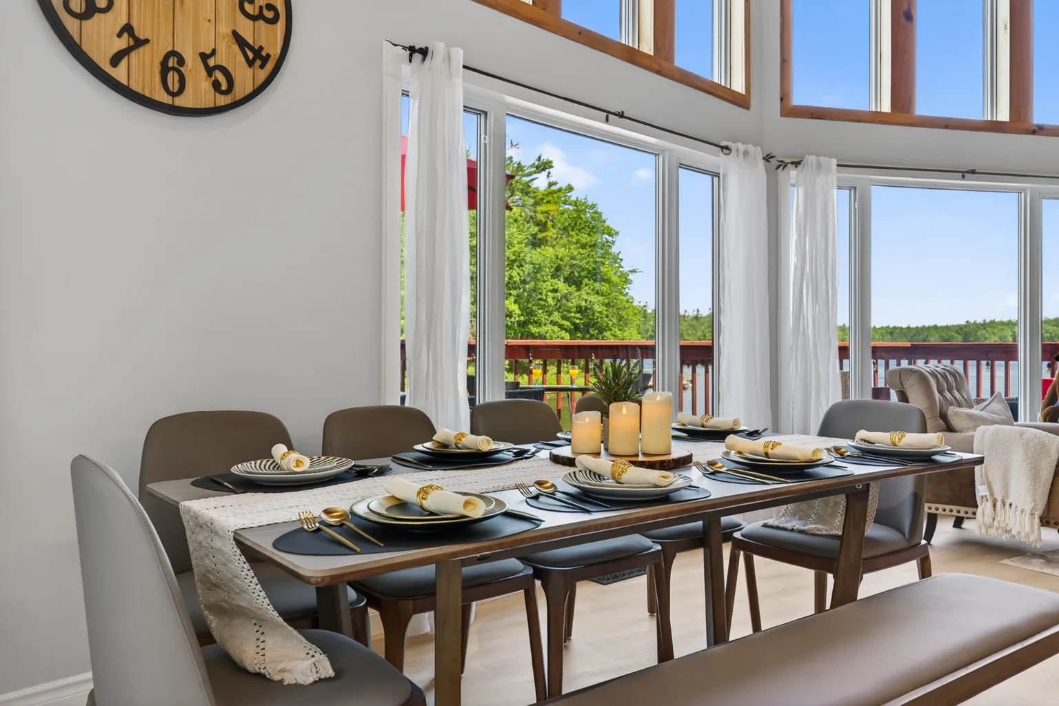 Dining table set for a crowd under tall windows at Good Times