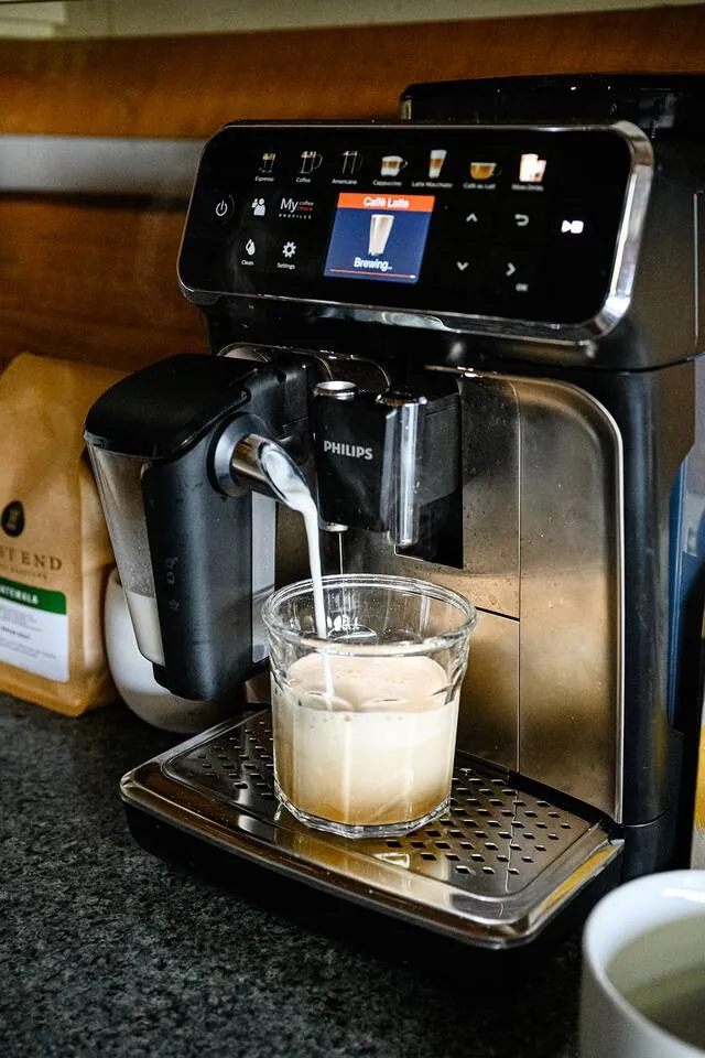 Fully automatic coffee machine at Hemlock Hideaway making a latte