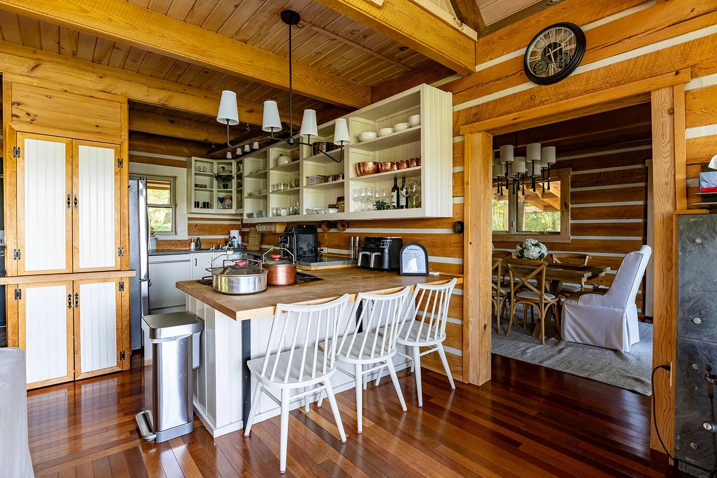 Wood kitchen at Hemlock Hideaway with a white island and stools