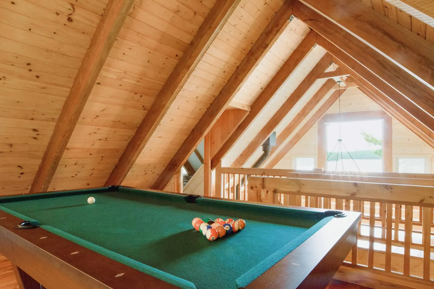 Pool table in the timber-framed loft at Hemlock Hideaway, overlooking the living room