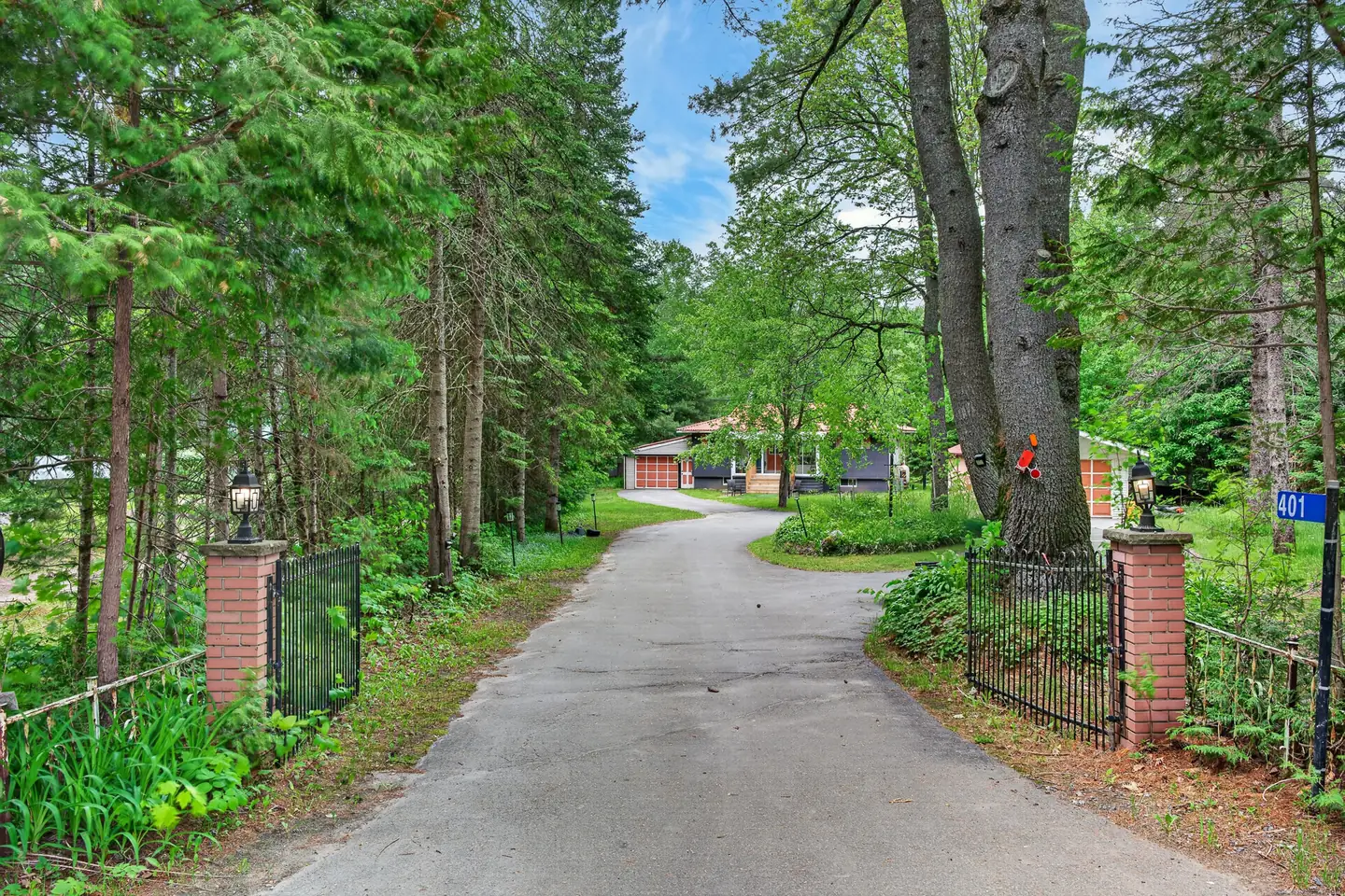 Gated, tree-lined private driveway leading through the woods to The Mara
