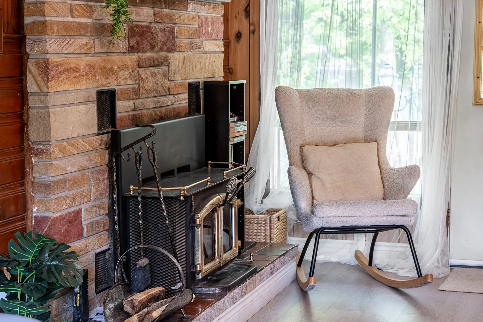 Rocking chair beside the wood stove in a sunny corner of The Mara