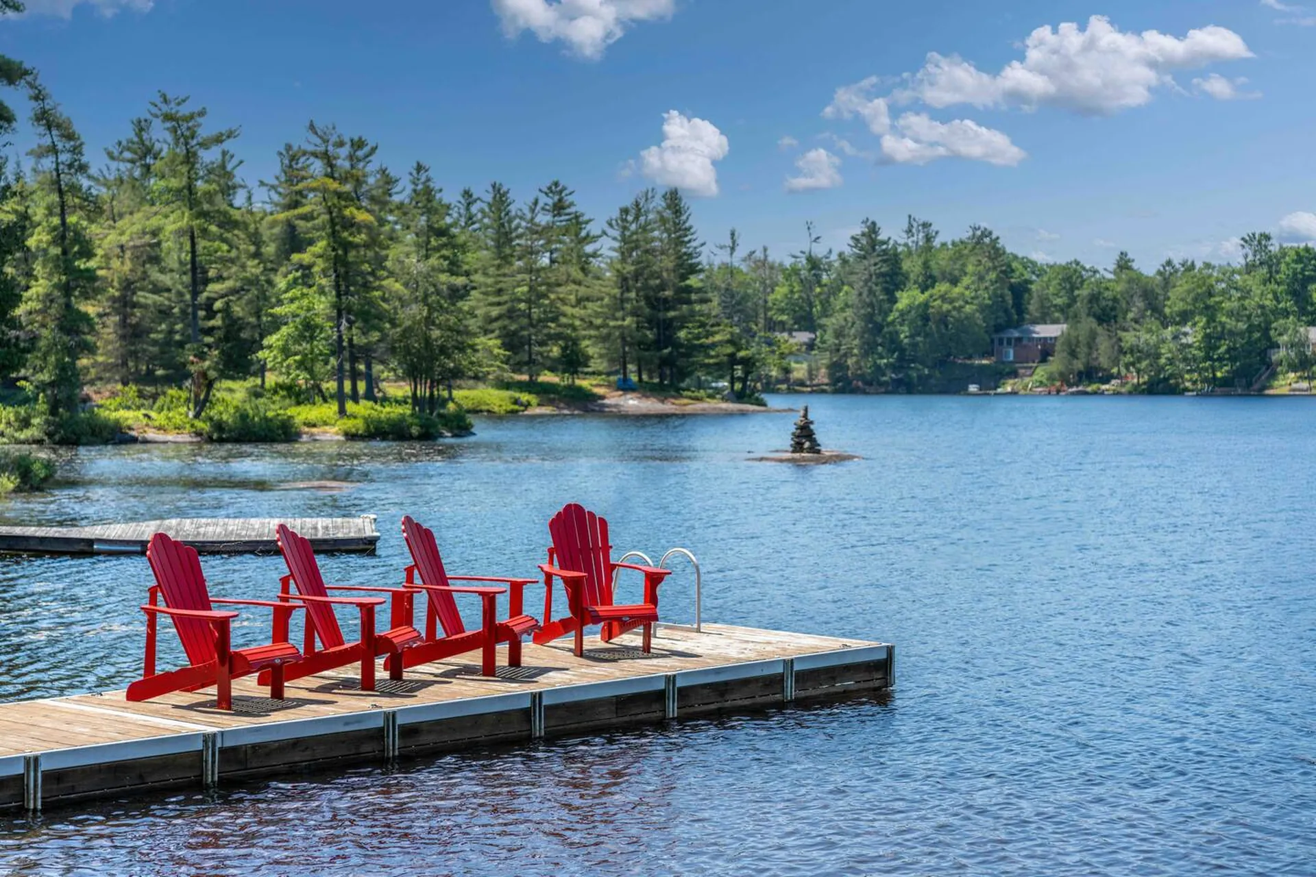 Lakefront cottage dock with red chairs Lakefront cottage dock with red chairs