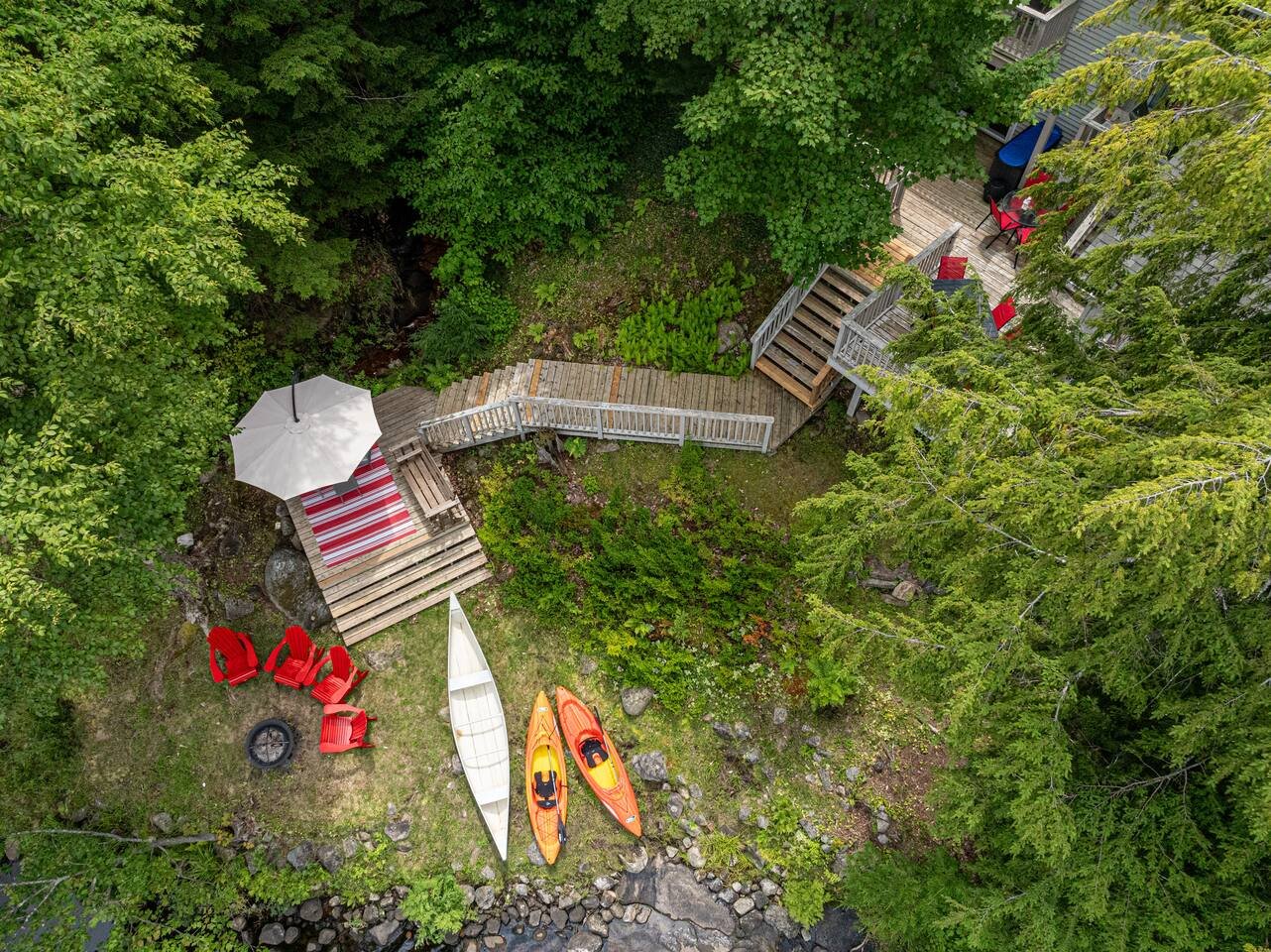 Aerial view of the Brandy Lake cottage with deck, kayaks and private dock