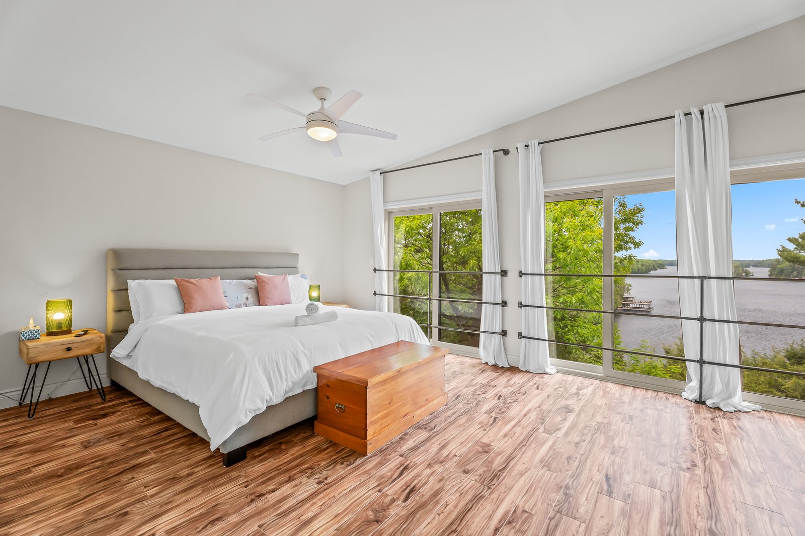 Waterfront bedroom with floor-to-ceiling windows