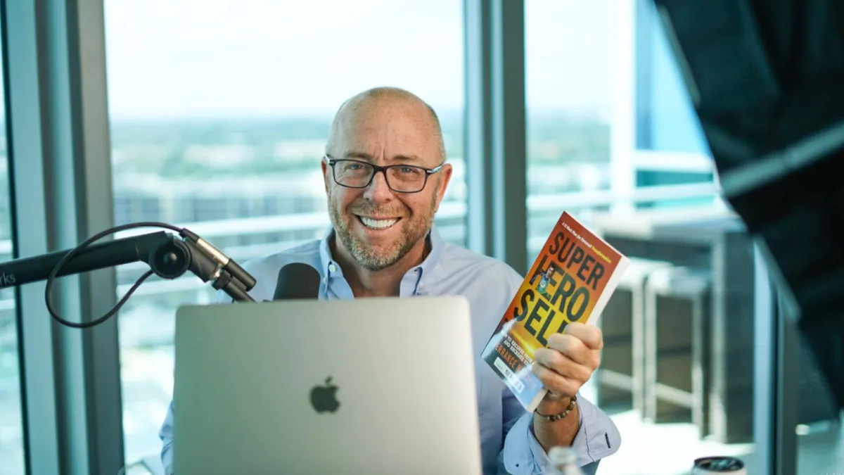 Terrance McMahon holding his book SuperHero Self