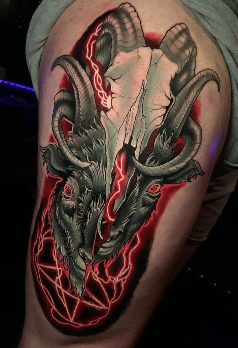 Goat skull with glowing red cracks tattoo