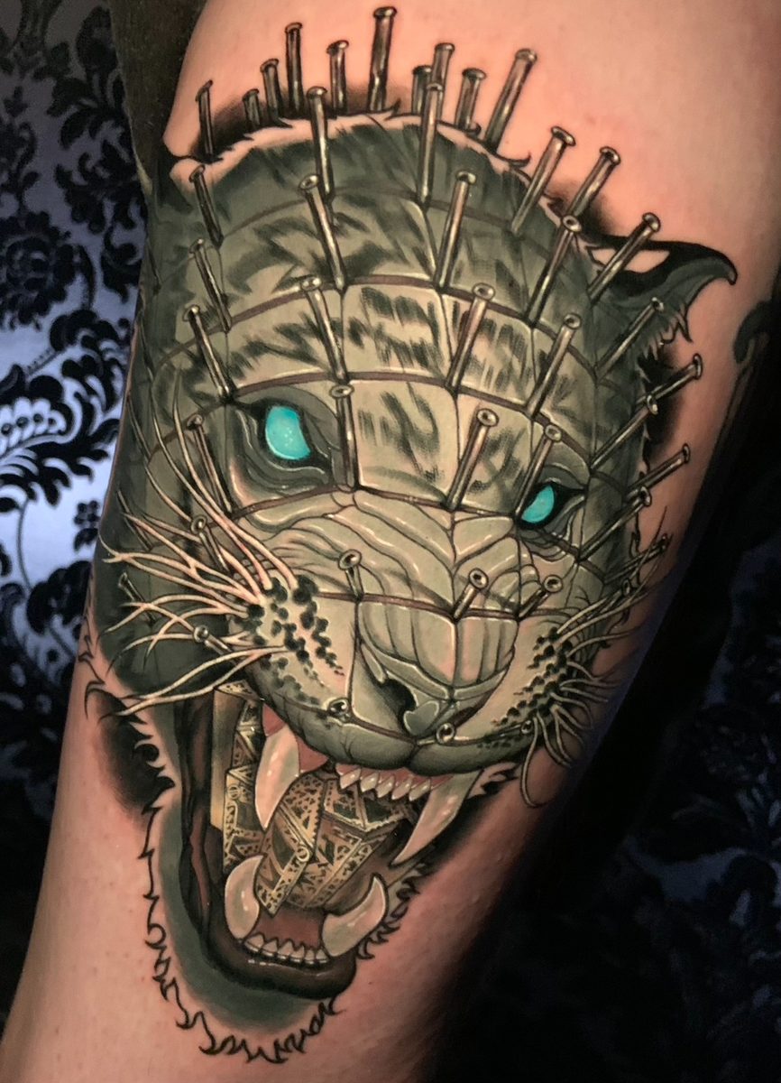 Lion with nails tattoo