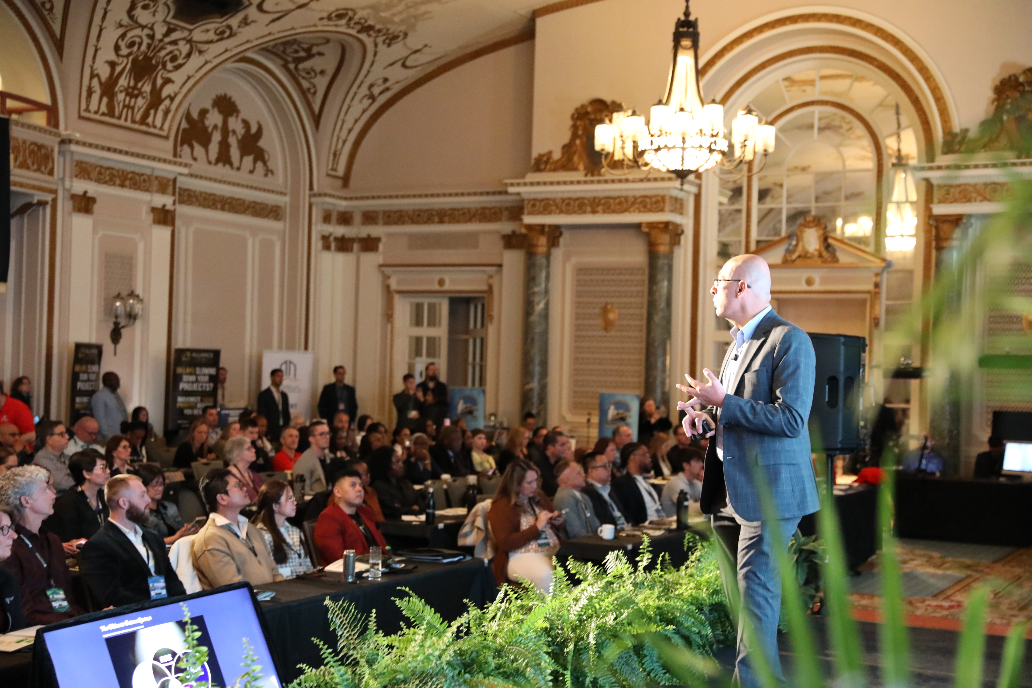 Fadi Habib presenting live on stage to a full room