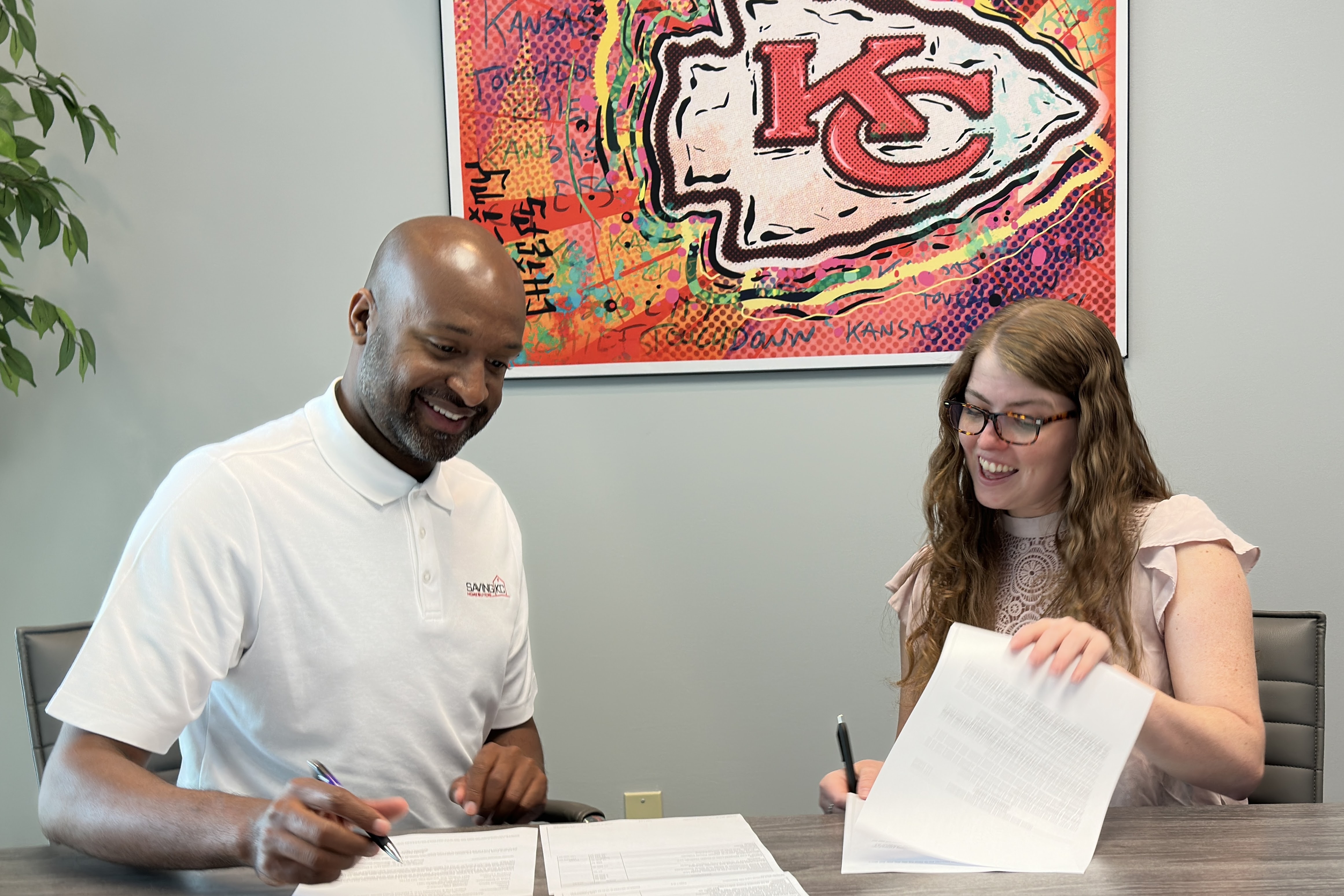 Ernest Dodson at closing table with happy Kansas City home seller