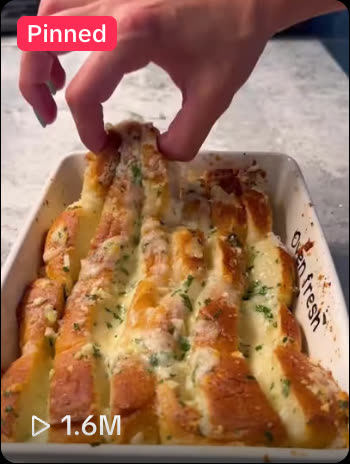 TikTok grid tile on @themegansteinberger, a baked cheesy bread recipe, showing 1.6M views