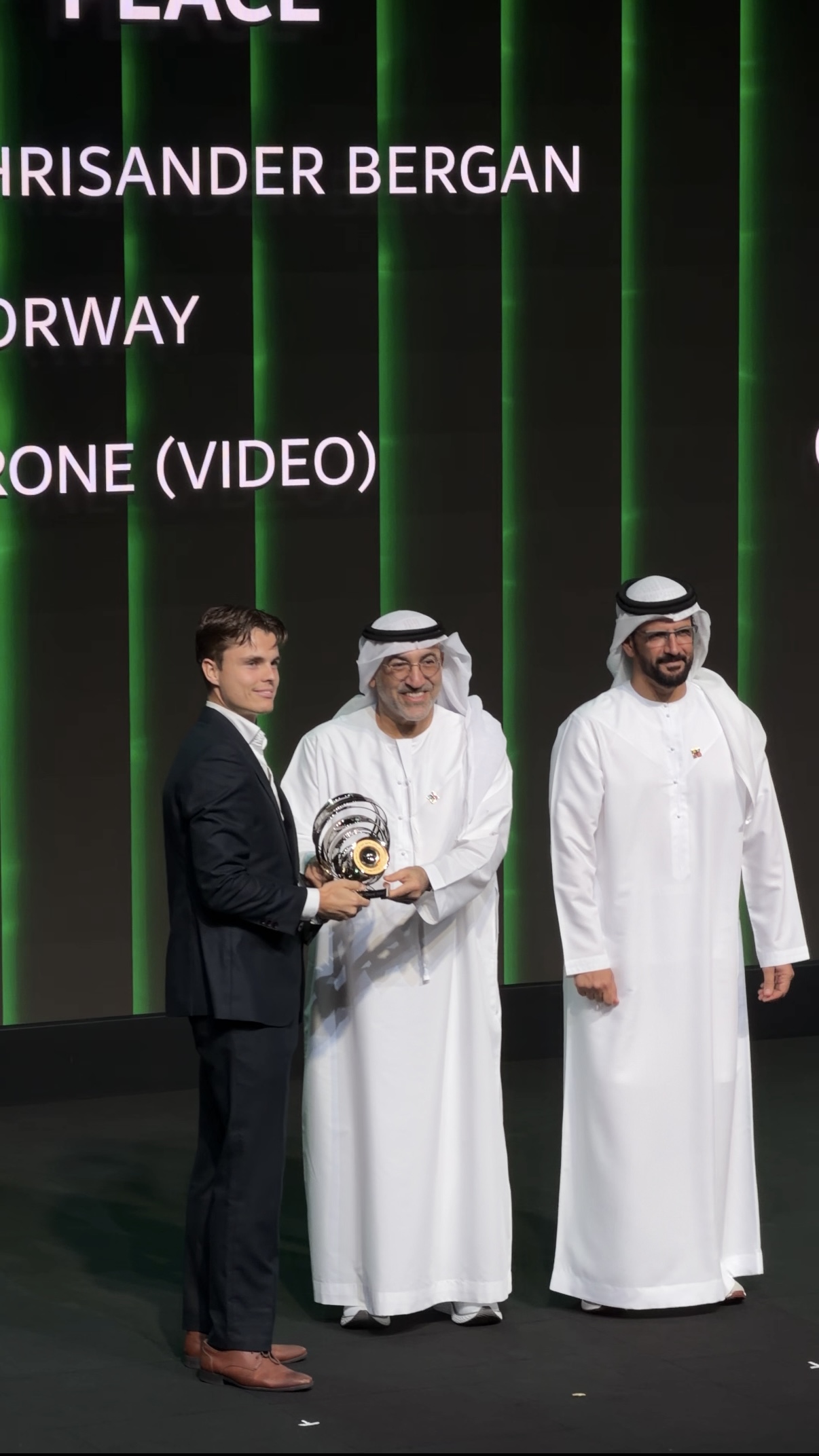 Chris receiving second place in Drone (Video) on stage at HIPA 2025 in Dubai