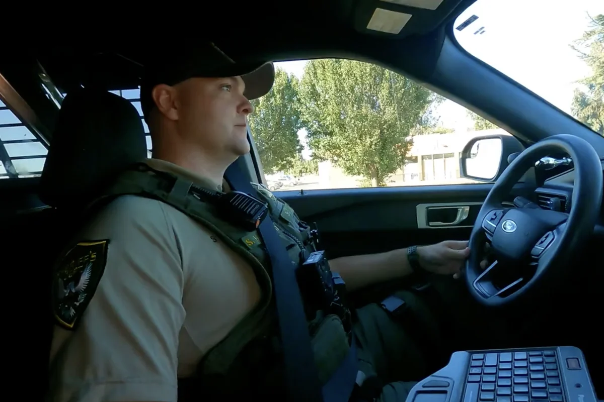 Deputy driving a patrol SUV while wearing a body camera