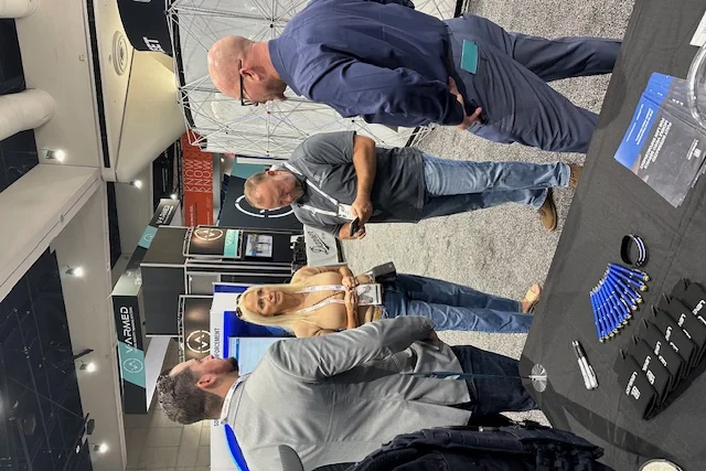LensLock team in conversation at the LensLock booth