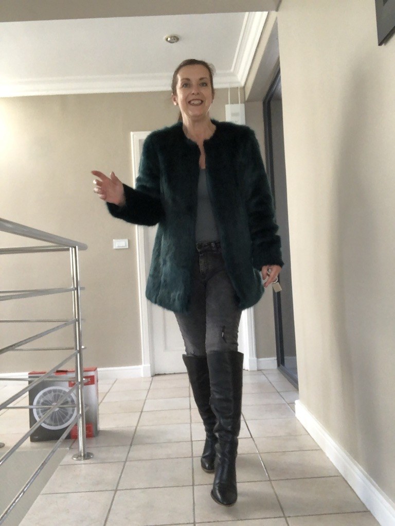Clare Maxfield in jeans and knee-high boots, wearing the styles that suit her