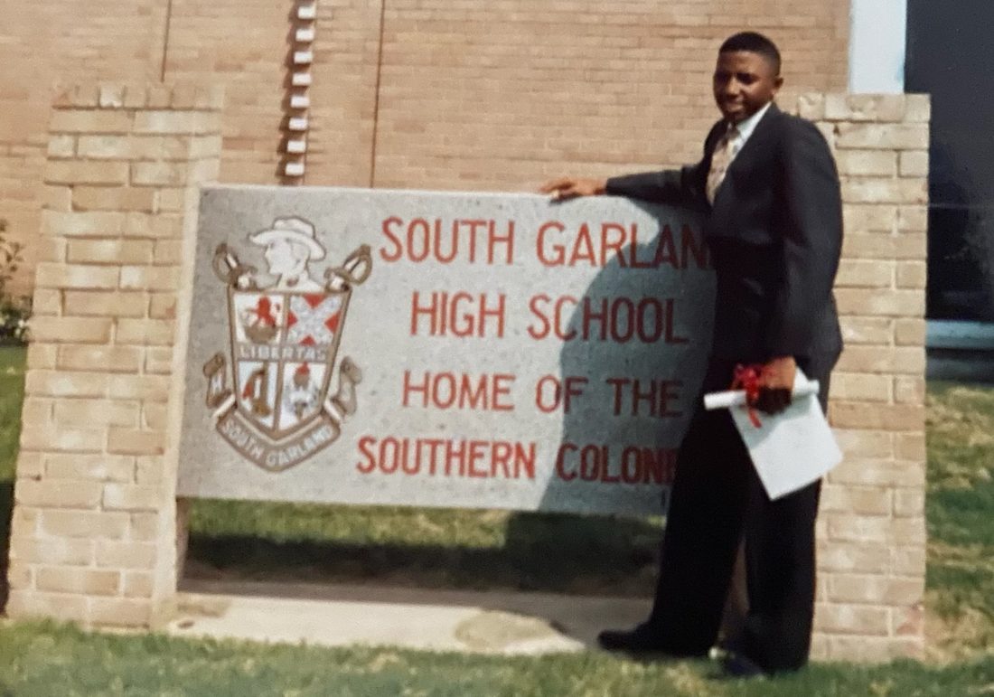 Bryan at the South Garland High School sign on graduation day