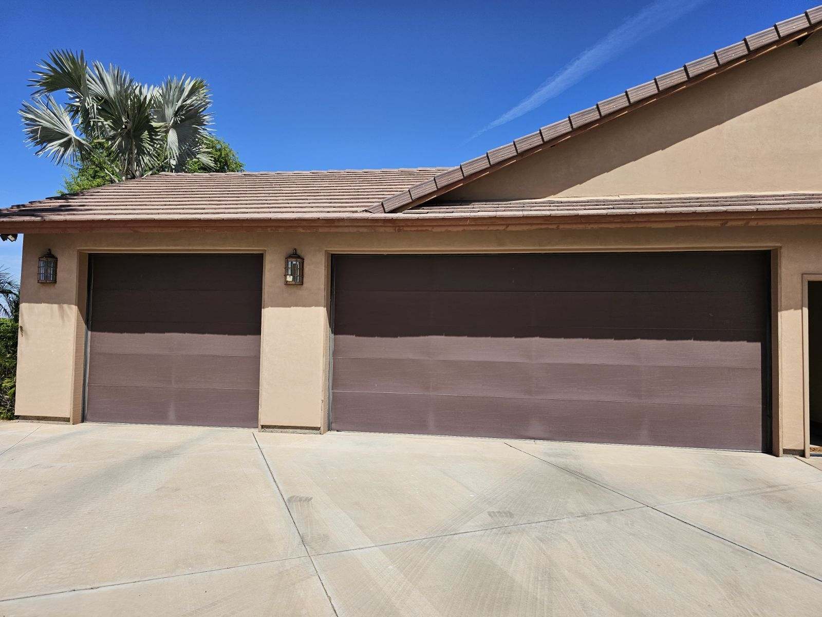 Old damaged garage door before replacement in Yuma, AZ