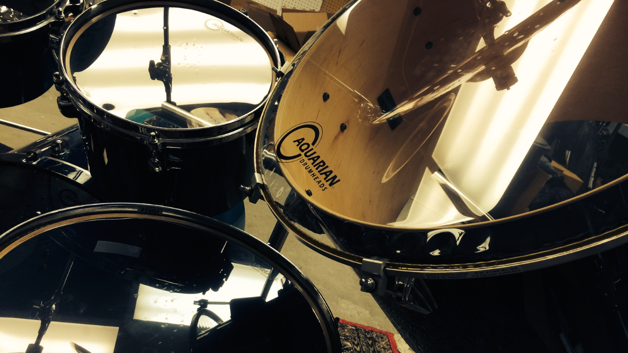 Close-up of Tim Alexander’s drum kit, showing the drums and reflective drumheads. Close-up of Tim Alexander’s drum kit, showing the drums and reflective drumheads.