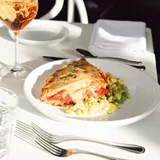 Tomato pie plated on the patio at Mozelle's