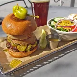 Burger, side salad and craft beer at Hops Burger Bar