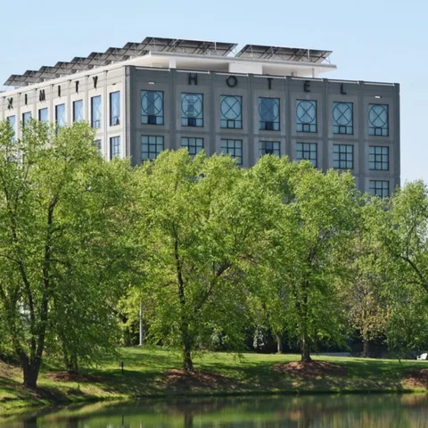 Photo: Proximity Hotel website The Proximity Hotel building above the trees along the creek (Photo: Proximity Hotel website)