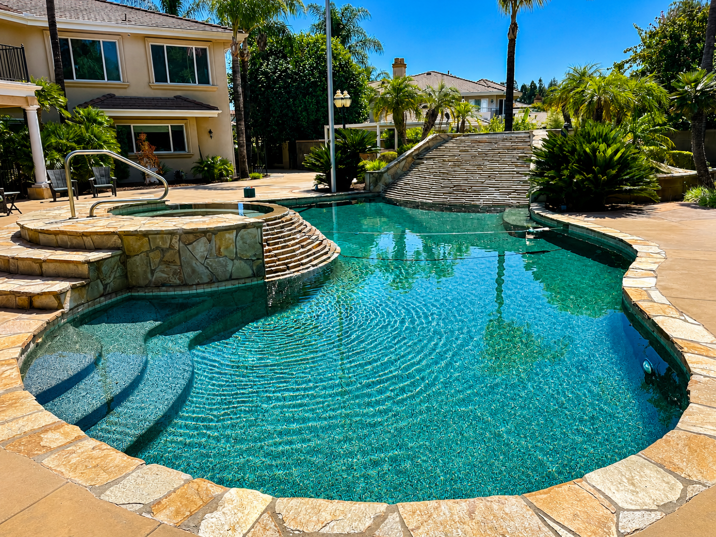 Pool cleaning service in Riverside backyard pool with sparkling blue water